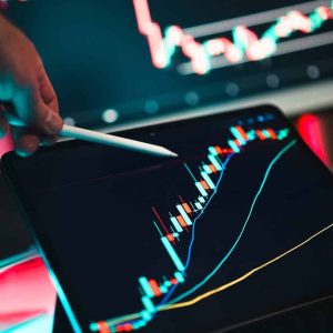 Close-up of cryptocurrency trading analysis on a digital tablet, highlighting market trends.